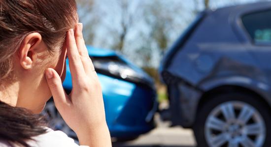 Woman Holding Head with Crashed Cars in Front of Her Needing Car Insurance in Quincy, FL 