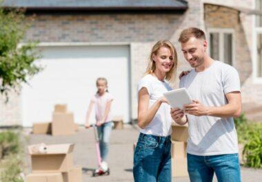 Family in Tallahassee, FL reviewing their home Insurance policy in front of their home